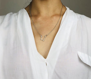 Silver Aquarius Sign Necklace worn on a model  