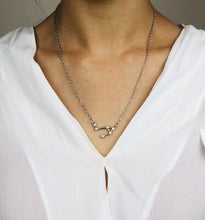 Load image into Gallery viewer, A Silver Libra Constellation Necklace on a model.
