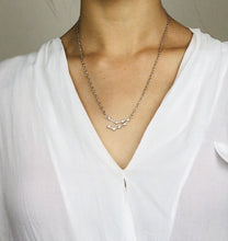 Load image into Gallery viewer, A Silver Capricorn Sign Necklace worn on a model.
