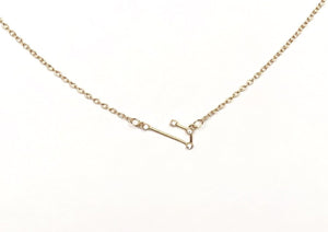 Front of a gold Aries Zodiac Constellation Necklace on a white background