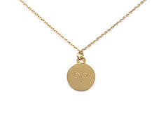 Load image into Gallery viewer, An aries symbol on the back side of a Gold Aries Zodiac Coin Necklace on a white background.
