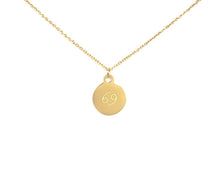 Load image into Gallery viewer, Back side of a gold Cancer Zodiac Coin Necklace with a symbol that resembles the number 69.
