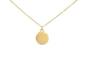 Back side of a gold Cancer Zodiac Coin Necklace with a symbol that resembles the number 69.