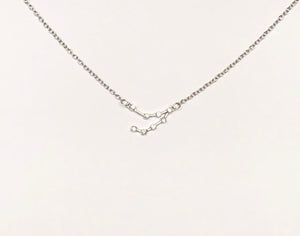 A Silver Capricorn Zodiac Constellation Necklace on a white background.