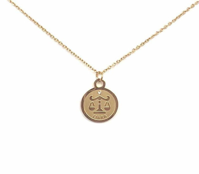 The front side of a gold Libra Medallion Necklace on a white background.