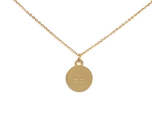 A Libra Sign Symbol, which is on the back side of the Libra Gold Zodiac Coin is on a white background. 