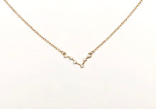 Load image into Gallery viewer, The front side of a gold Pisces Zodiac Constellation Necklace is on a white background.
