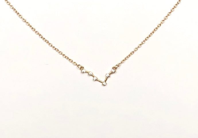 The front side of a gold Pisces Zodiac Constellation Necklace is on a white background.