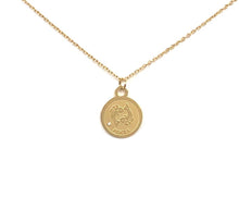 Load image into Gallery viewer, The front side of a gold Pisces Medallion Necklace that showcased two fish-like symbol on a white background.
