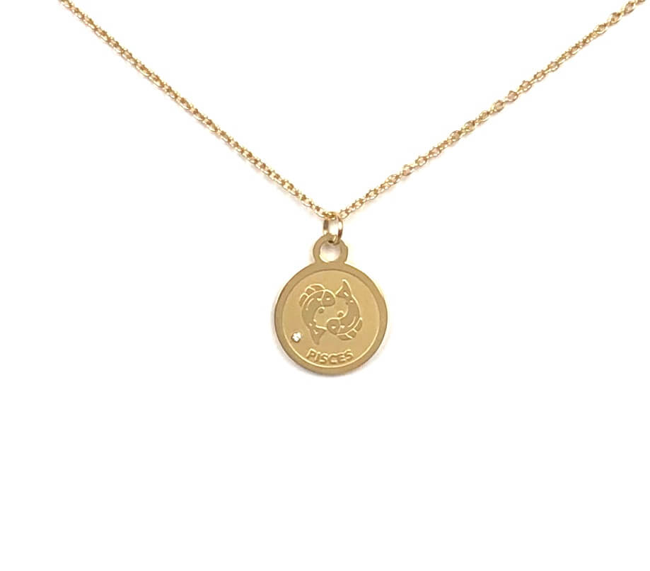 The front side of a gold Pisces Medallion Necklace that showcased two fish-like symbol on a white background.