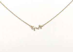 A gold Scorpio Zodiac Constellation Necklace is on a white background. 