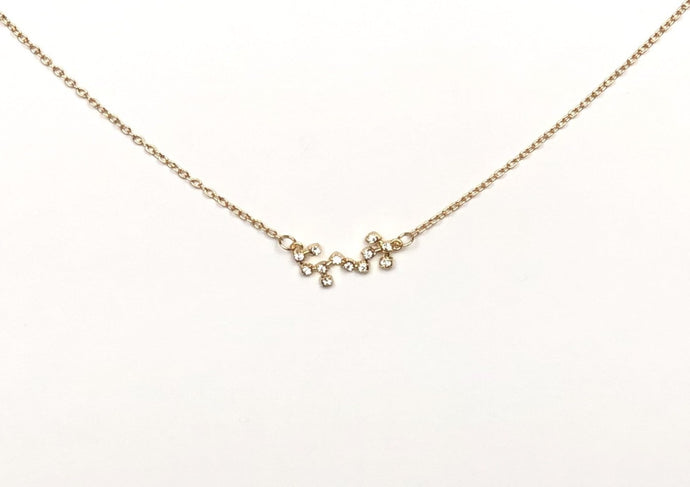 A gold Scorpio Zodiac Constellation Necklace is on a white background. 