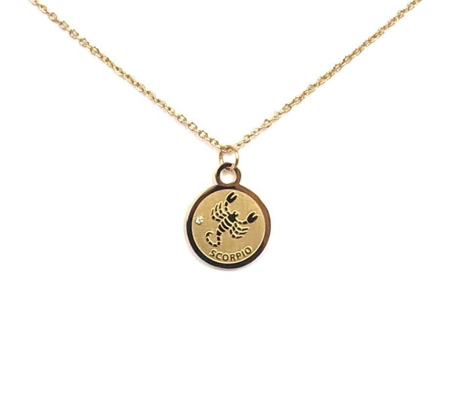 The Front side of a gold Scorpio Medallion Necklace is on a white background. 