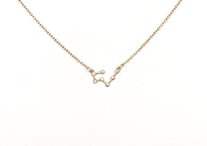 A gold Taurus Zodiac Constellation Necklace is on a white background.