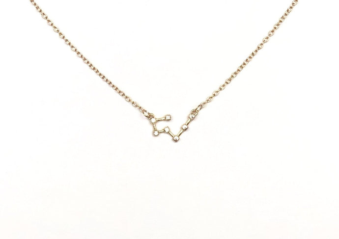 A gold Taurus Zodiac Constellation Necklace is on a white background.