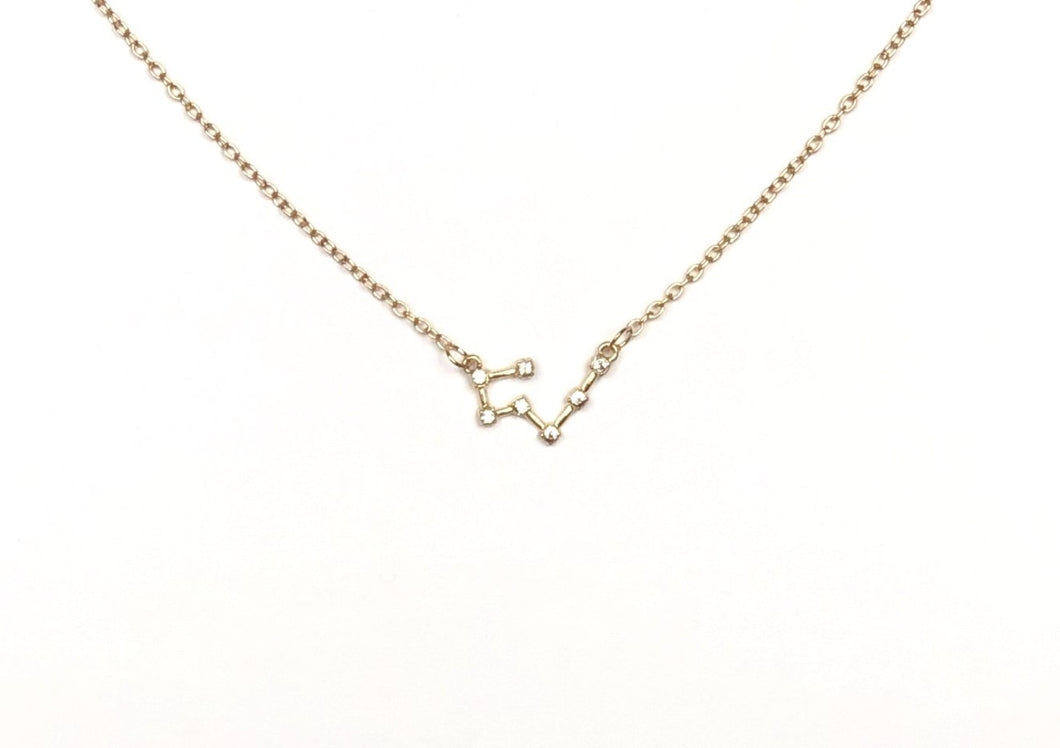 A gold Taurus Zodiac Constellation Necklace is on a white background.