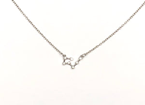 A silver Taurus Zodiac Constellation Necklace is on a white background. 