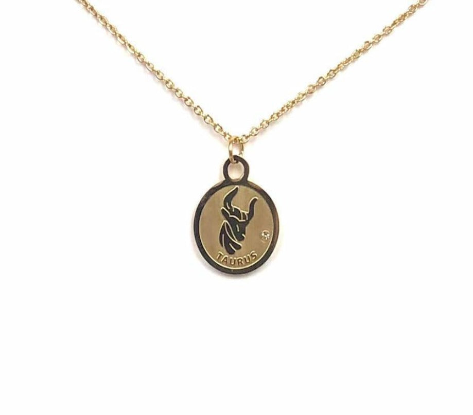 The front side of a gold Taurus Medallion Necklace is on a white background. 