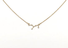 Load image into Gallery viewer, The front side of a gold Virgo Zodiac Constellation Necklace on a white background. 
