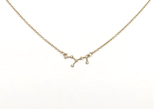 The front side of a gold Virgo Zodiac Constellation Necklace on a white background. 