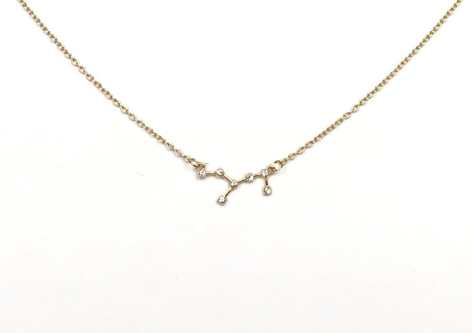 The front side of a gold Virgo Zodiac Constellation Necklace on a white background. 