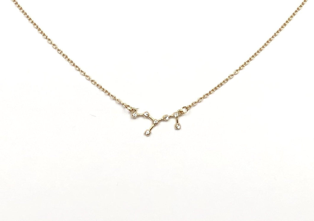 The front side of a gold Virgo Zodiac Constellation Necklace on a white background. 