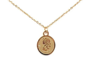 The front side of a gold Virgo Medallion Necklace that features a lady-like symbol on a white background. 