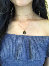 Load image into Gallery viewer, Back side of gold Cancer Symbol Necklace, pairing with a gold dainty choker, worn on a model. 
