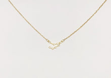 Load image into Gallery viewer, A gold Capricorn Zodiac Constellation Necklace on a white background.
