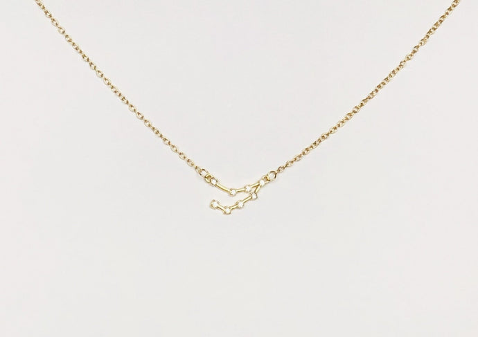 A gold Capricorn Zodiac Constellation Necklace on a white background.