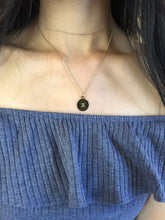 Load image into Gallery viewer, A gold Gemini Symbol Necklace worn on a model.
