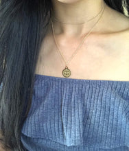 Load image into Gallery viewer, It&#39;s showing the front side of the Libra Zodiac Sign Necklace, that is worn on a model.
